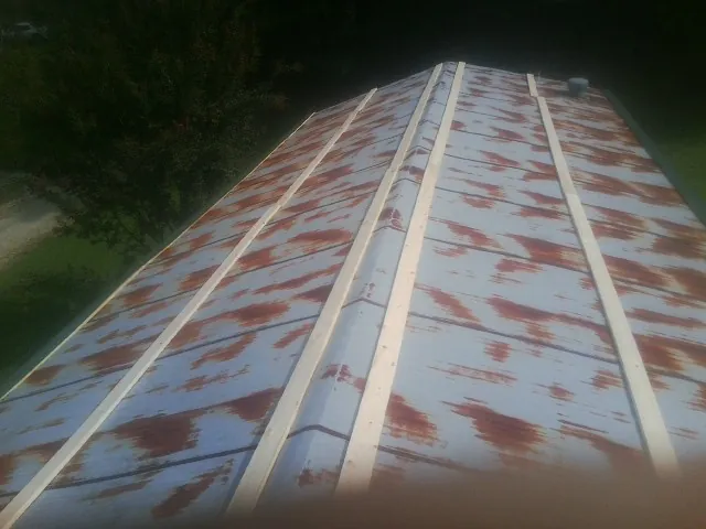 Rusted metal roof panels with new wood purlins before replacement — Storm Damage Roof Repair in Washington Boro by Roofing Brothers