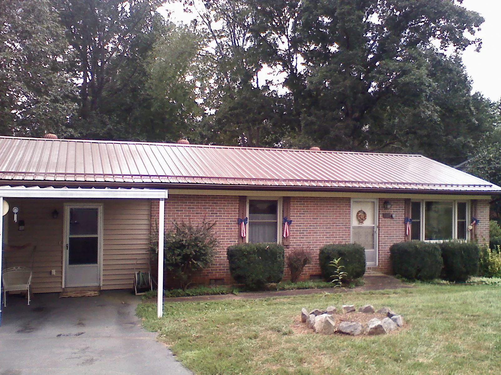 Bronze metal roof and carport on a brick ranch home — Roof Repair work by our crew in Washington Boro
